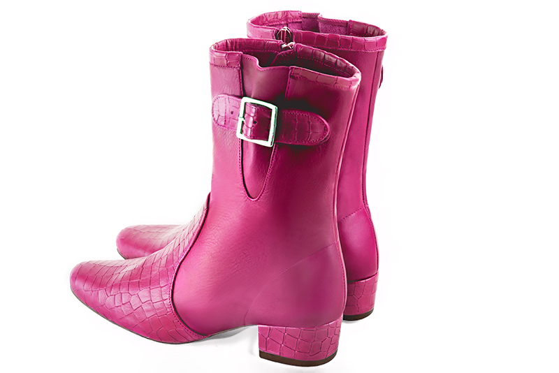 Fuschia pink women's ankle boots with buckles on the sides. Round toe. Low block heels. Rear view - Florence KOOIJMAN